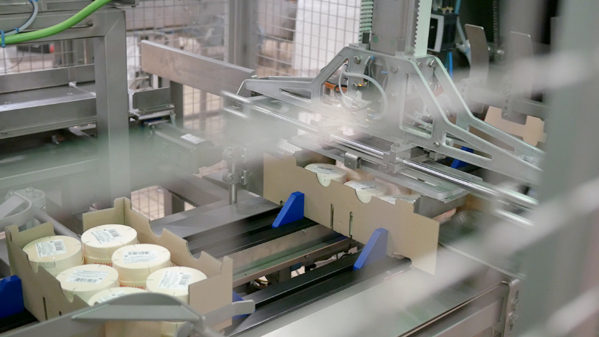 Wrap around case packer for trays products inside