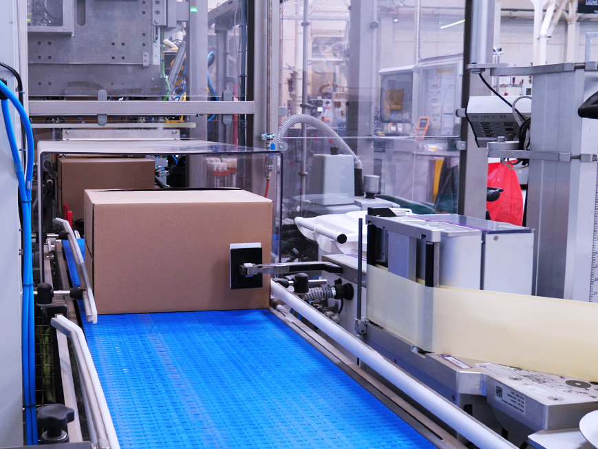 Wrap around case packer for trays with ledge cases exit